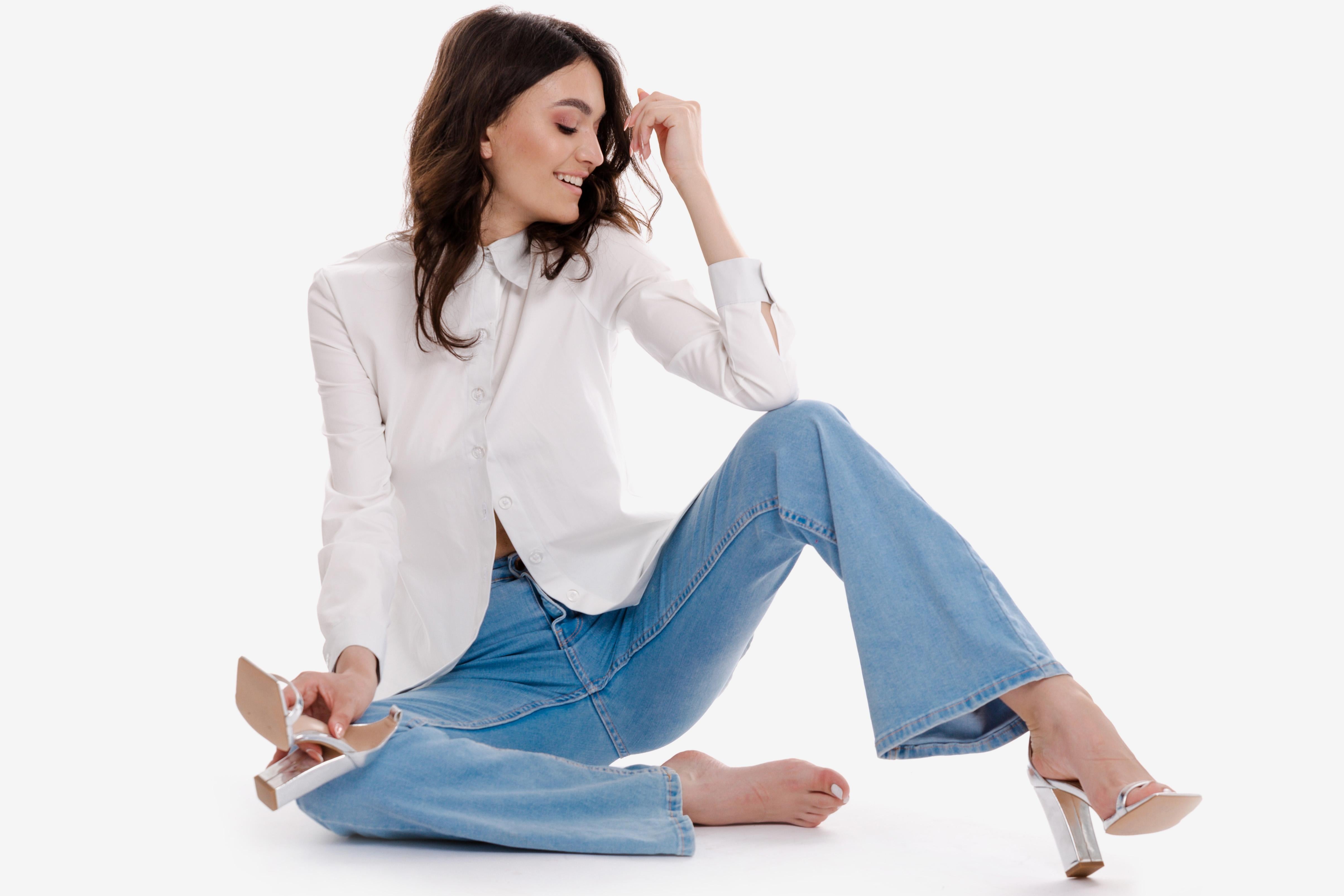 A stylish model wearing the Velmoft Clara classic white shirt and Nova Flare jeans, featured on the homepage banner promoting Velmoft’s new women’s fashion collection.